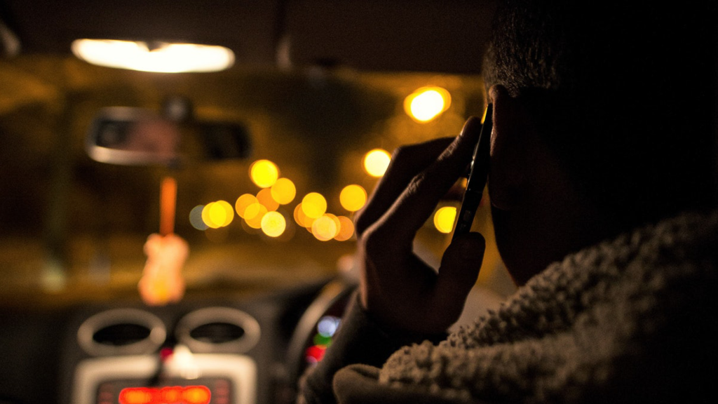 An image of a man on a mobile phone whilst driving