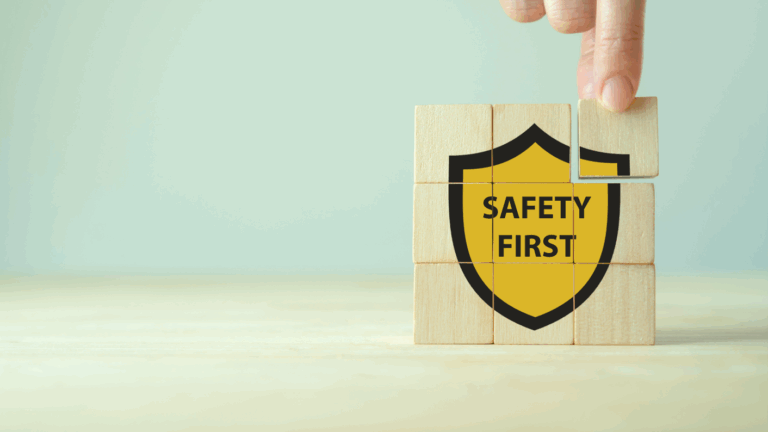 Image showing a hand picking up a safety first sign