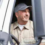 Professional driver seated in a vehicle representing company driver responsibility and safety